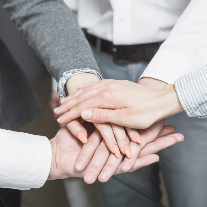 group-businesspeople-stacking-hands